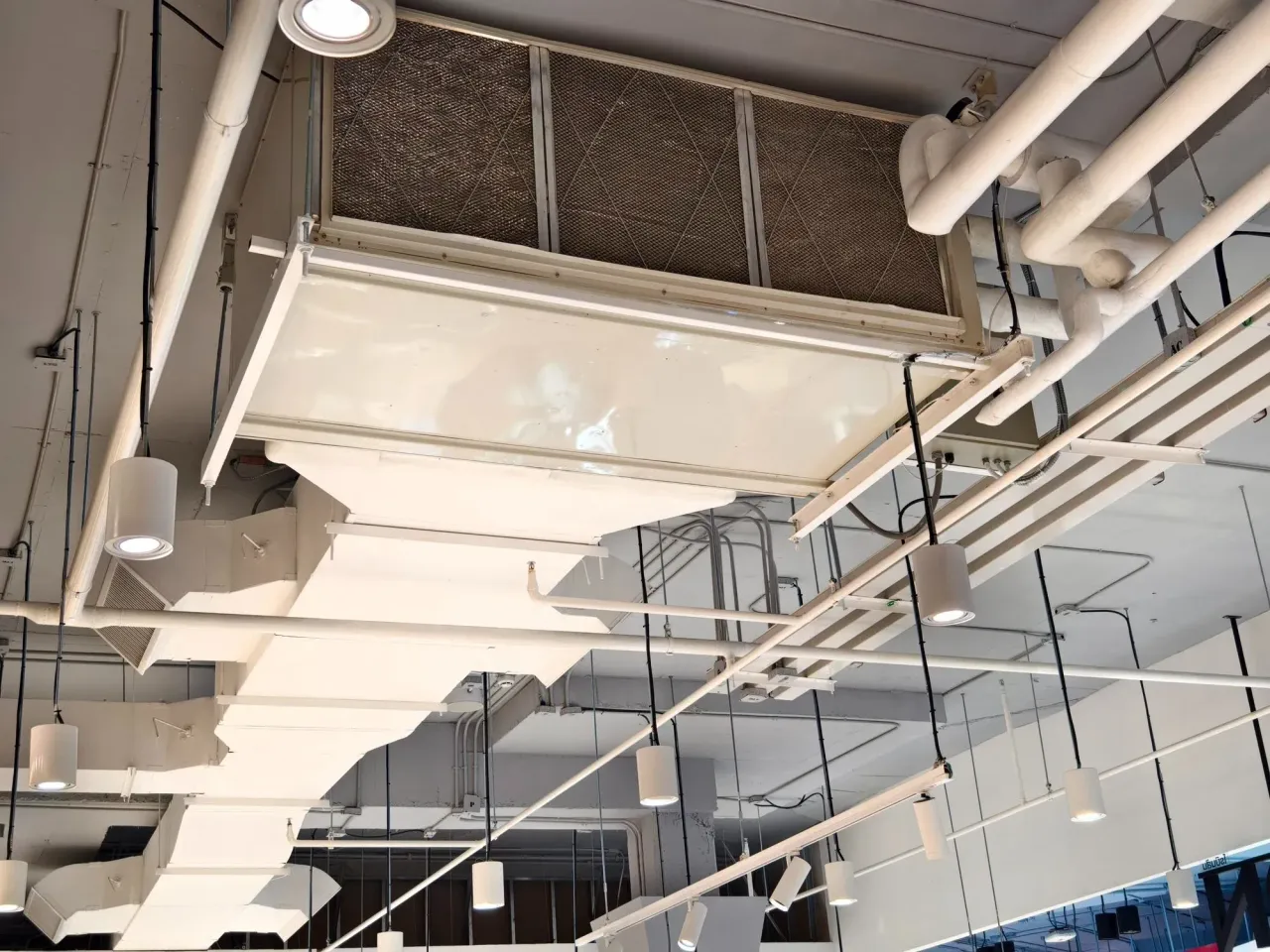 Exposed ceiling ductwork, air handler and piping in a commercial space