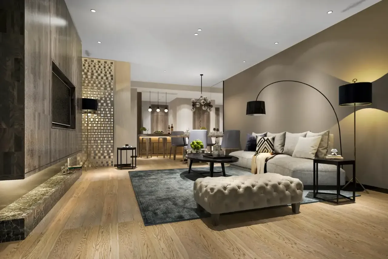 Modern living room with a gray sofa, hardwood floors and a dining area in the background